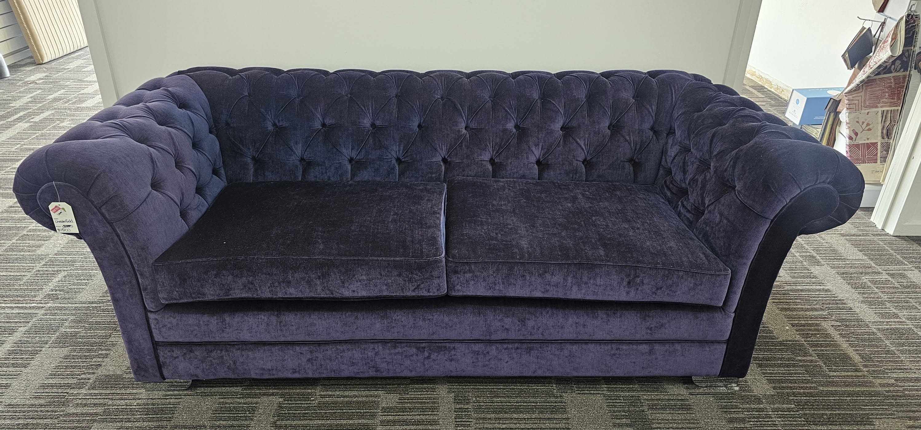 Deep purple button-tufted Chesterfield sofa with rolled arms